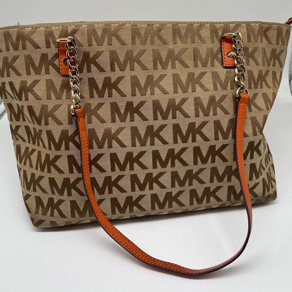 MICHAEL Michael Kors canvas tote with orange leather straps with gold chain.